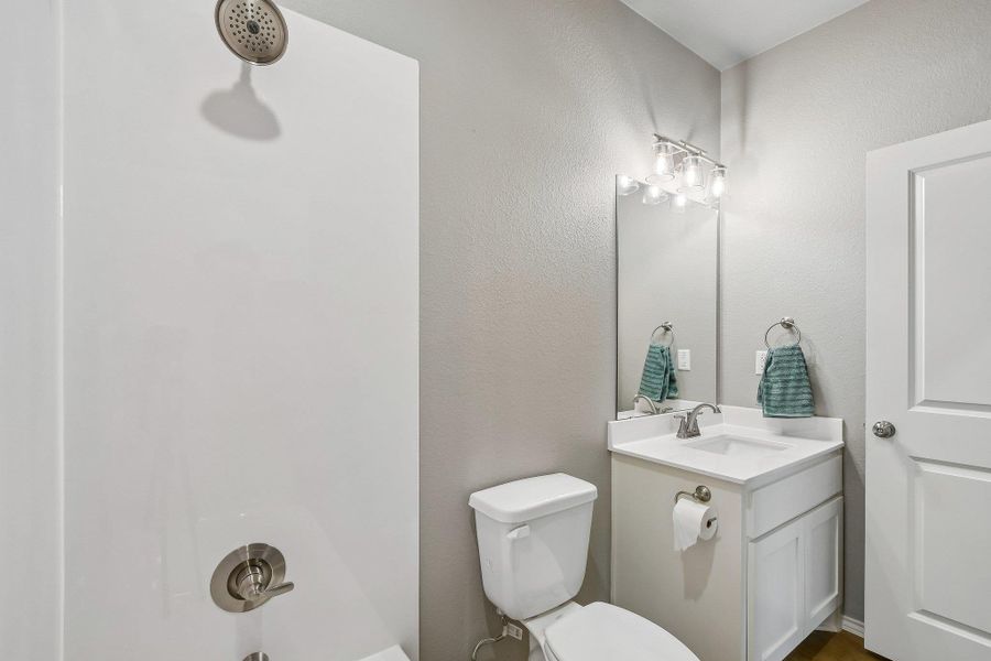A well-appointed bathroom offers a clean shower, a modern vanity, and a sleek toilet. A well-appointed bathroom offers a clean shower, a modern vanity, and a sleek toilet.