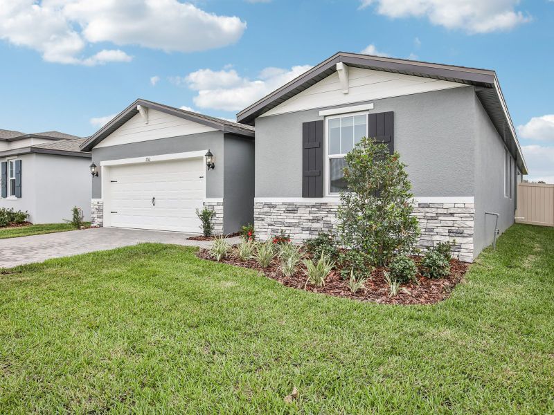 Front exterior of a new home in Two Rivers - Classic Series, Zephyrhills, FL, highlighting curb appeal (Image 17). Front exterior of a new home in Two Rivers - Classic Series, Zephyrhills, FL, highlighting curb appeal (Image 17).