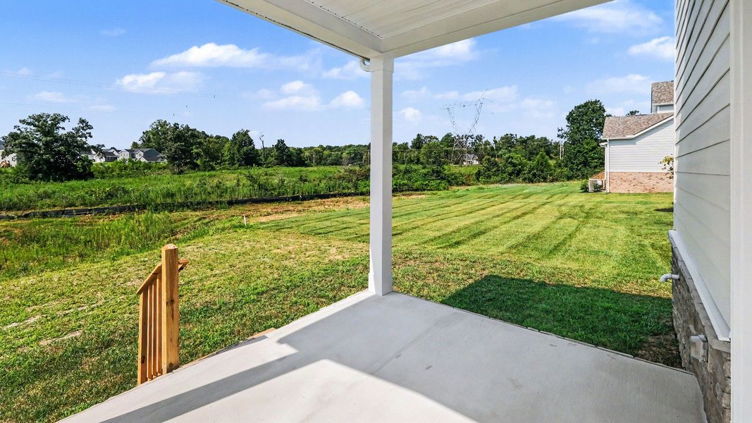 Rear covered porch with steps to backyard