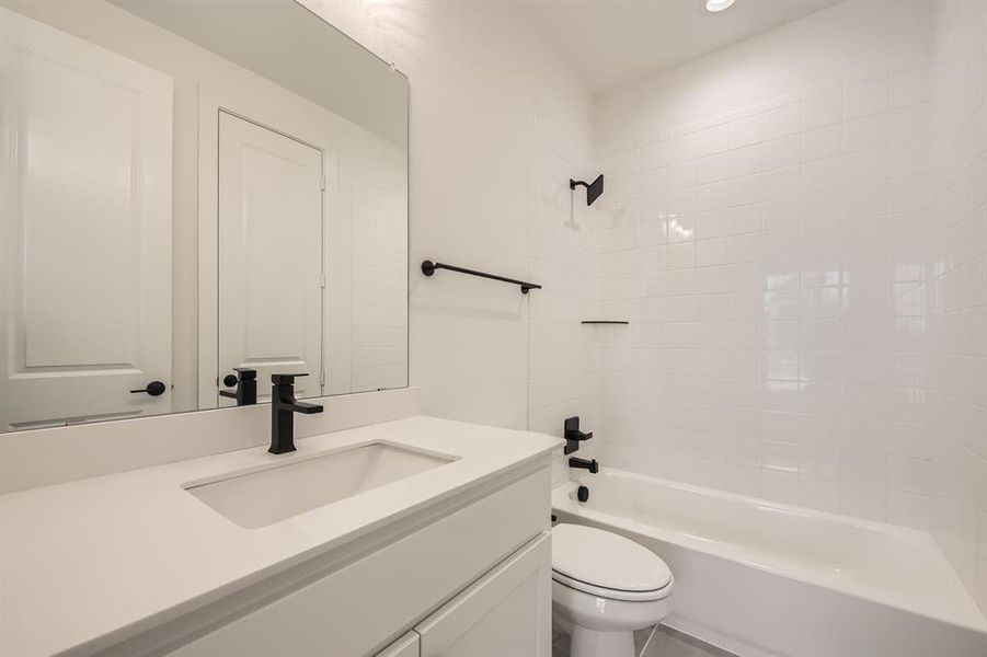 Full bath with vanity, toilet, shower / washtub combination, and recessed lighting
