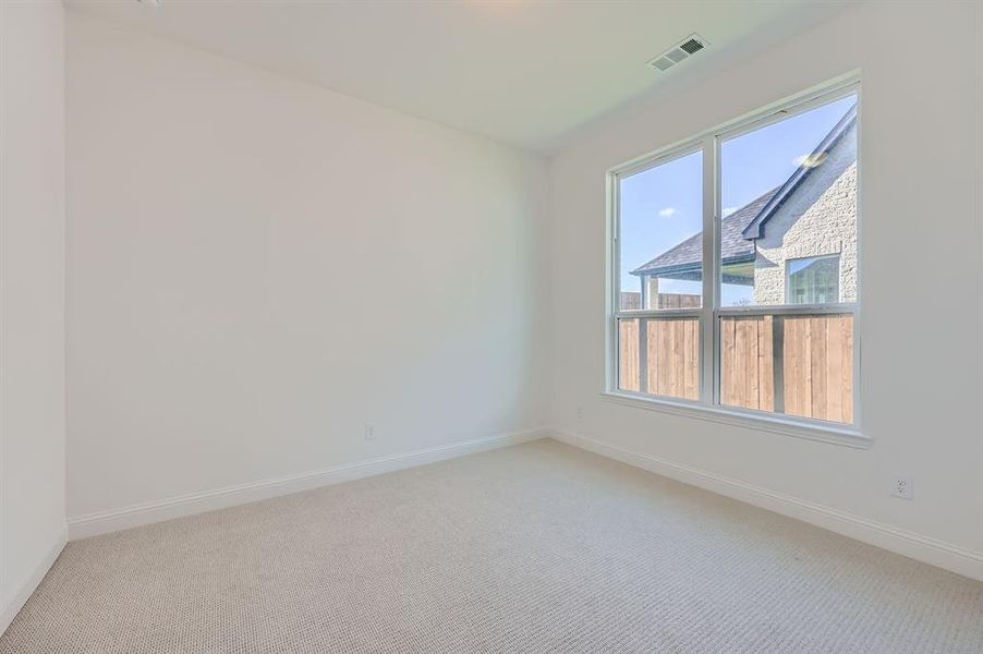 Spare room with light colored carpet