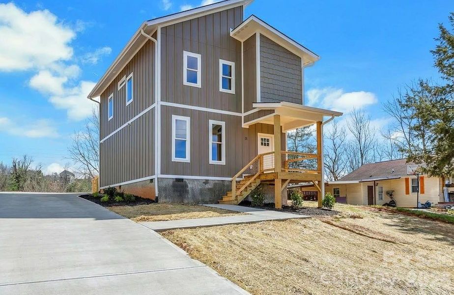 Front view with rendering of future concrete driveway and sidewalk