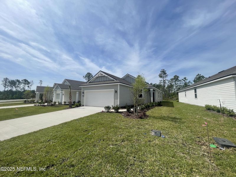 Front exterior of a new home in Palm Series at Seminole Palms, Palm Coast, FL, highlighting curb appeal (Image 2).