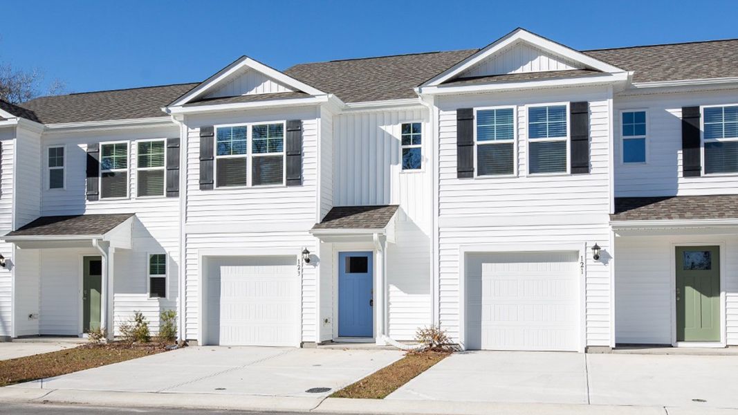 Front exterior of a new home in Waterside Townhomes, Surf City, NC, highlighting curb appeal (Image 1). Front exterior of a new home in Waterside Townhomes, Surf City, NC, highlighting curb appeal (Image 1).