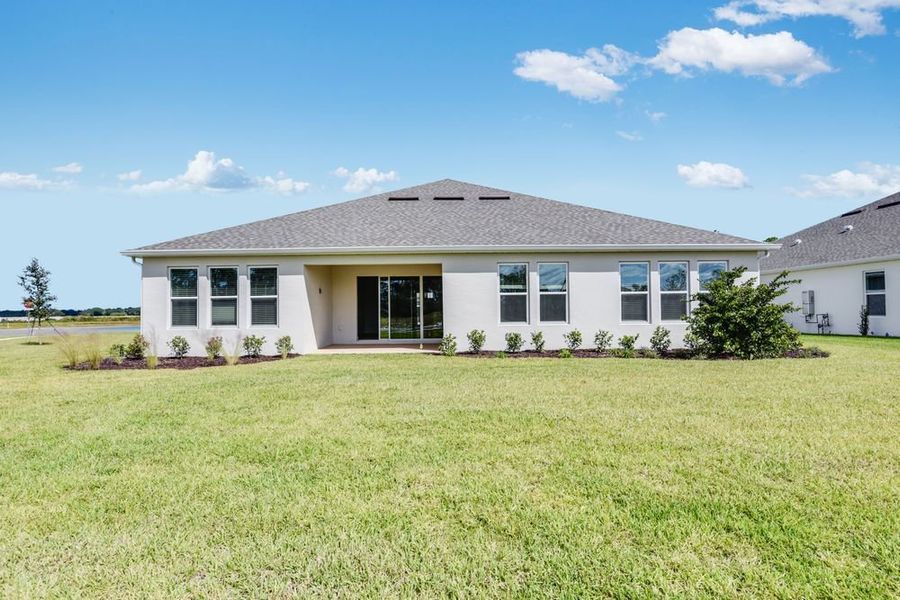 Exterior details and patio area of a home in Ardisia Park, New Smyrna Beach (Image 4).