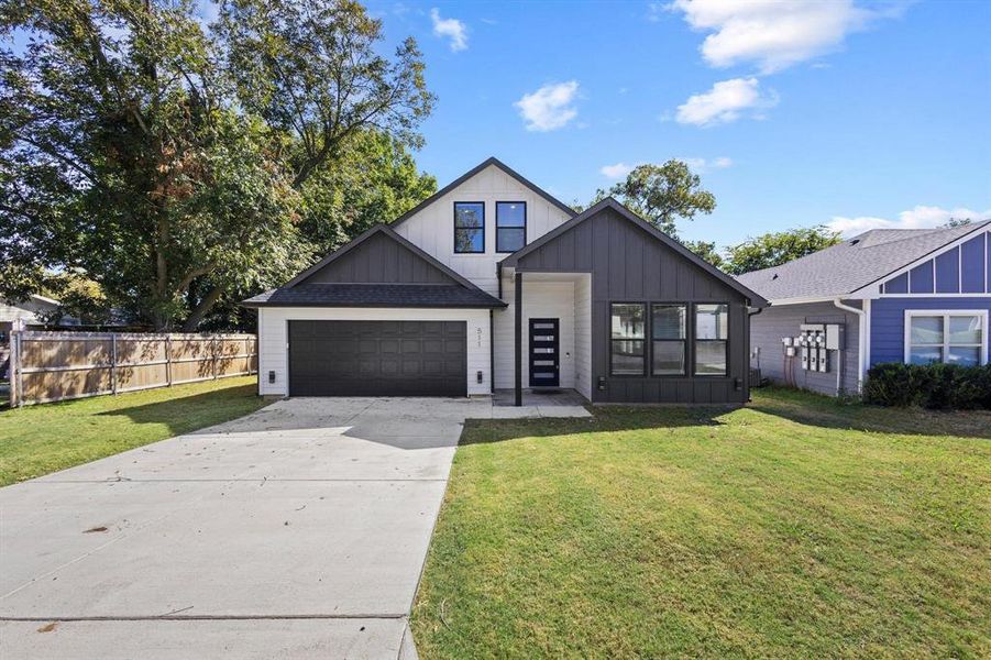 Modern farmhouse style home featuring board and batten siding, concrete driveway, and a garage