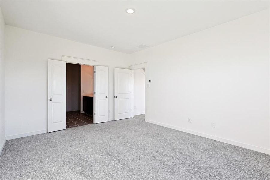 Unfurnished bedroom featuring dark carpet