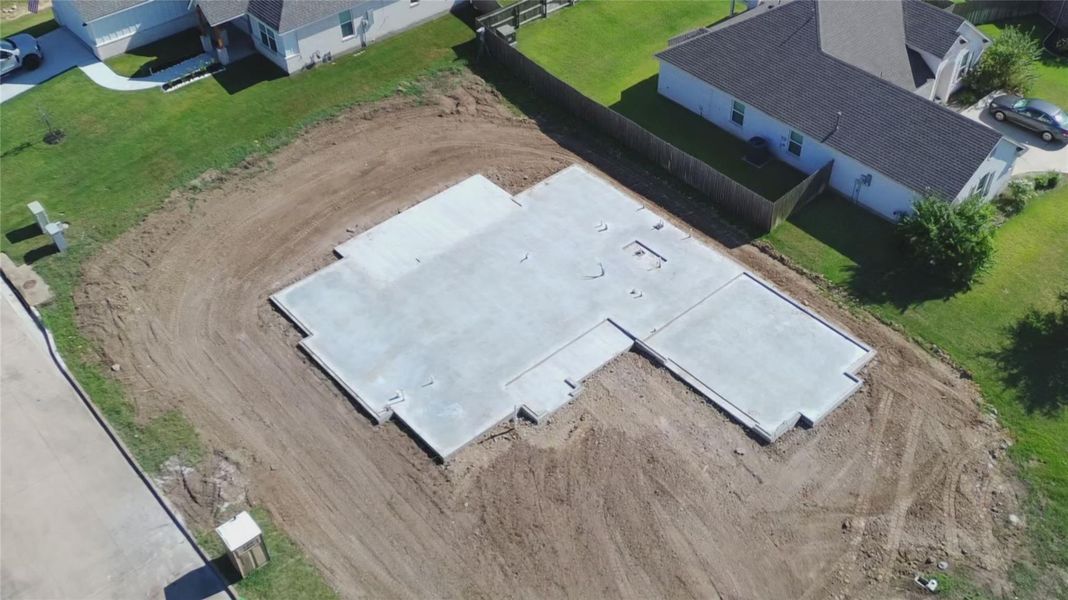 Aerial view of the homesite and construction progress, offering a look at the home’s footprint and corner lot setting.