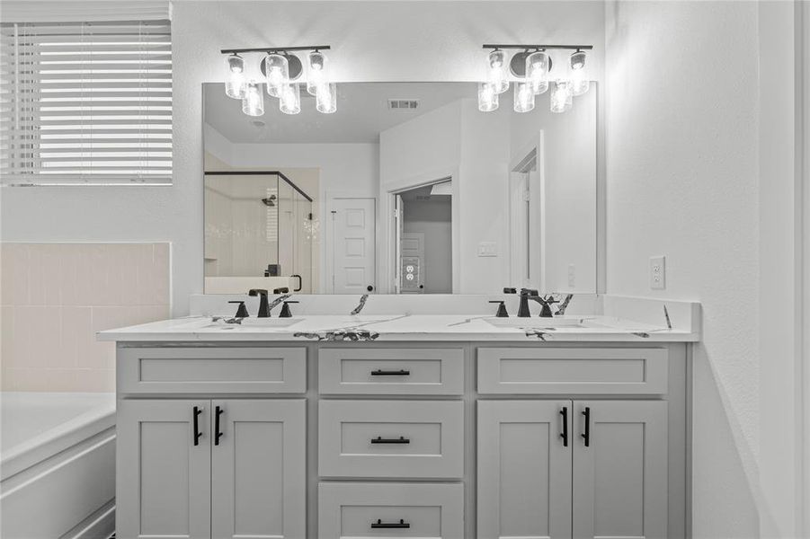 Enjoy primary suite bathroom with beautiful Silestone Quartz countertops and dual sinks.