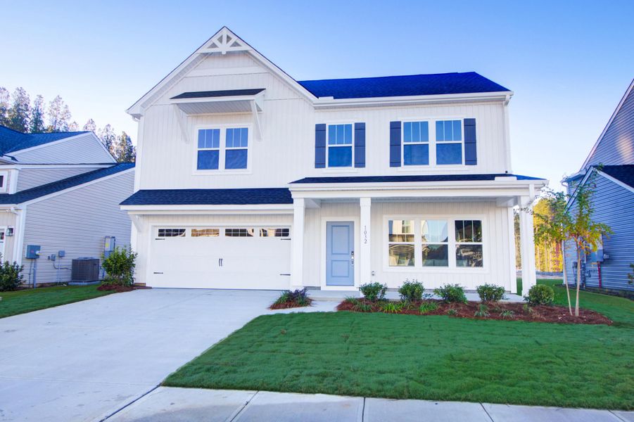 Front exterior of a new home in , Ravenel, SC, highlighting curb appeal (Image 1). Front exterior of a new home in , Ravenel, SC, highlighting curb appeal (Image 1).