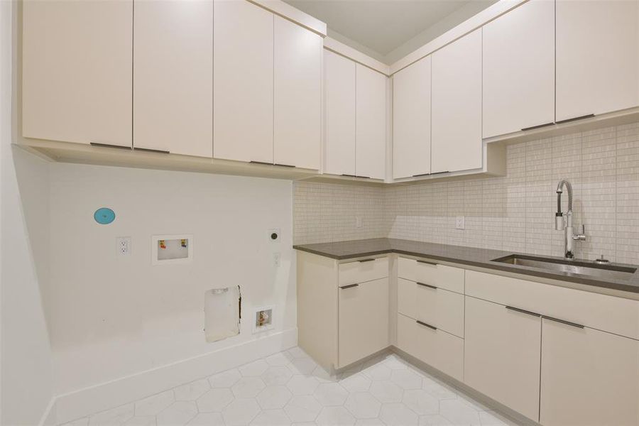 The utility room is located on the second floor and features large cabinets for storage and a sink for hand washing clothing. The first floor Primary has additional wash/dryer hook-ups for first floor laundry.