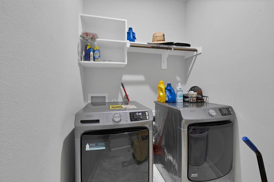 Laundry room featuring laundry area and separate washer and dryer