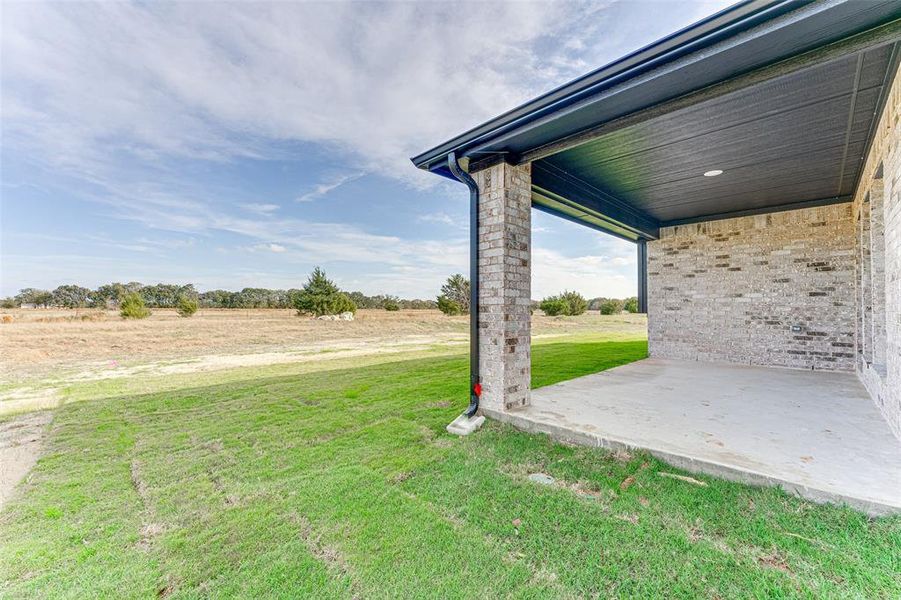 View of yard with a patio and a rural view