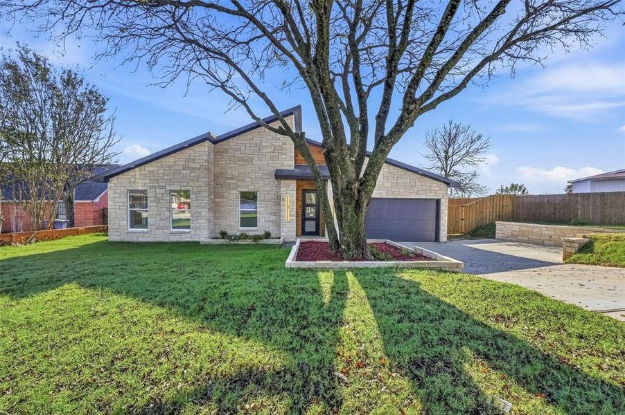 View of front of house with stone siding and concrete driveway View of front of house with stone siding and concrete driveway