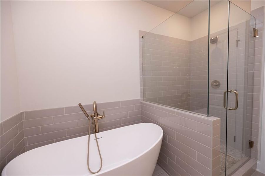 Bathroom with plus walk in shower and tile walls