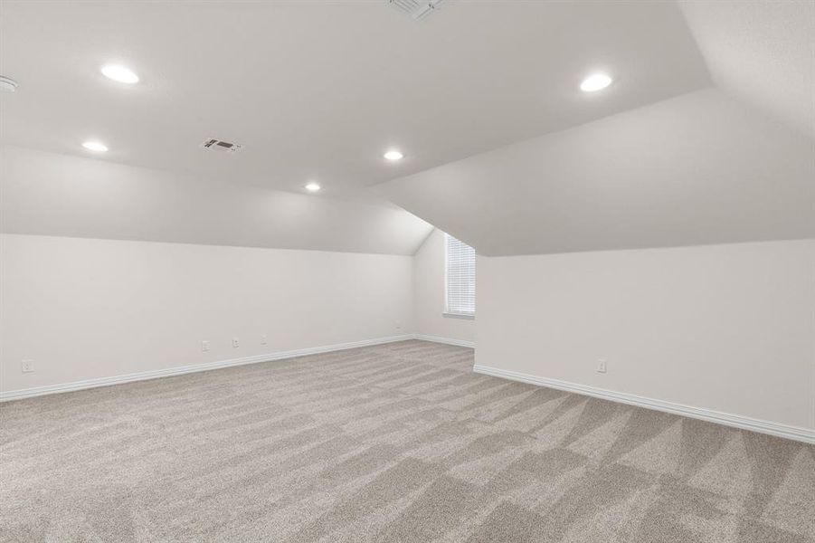 Bonus room with lofted ceiling, light colored carpet, and recessed lighting Bonus room with lofted ceiling, light colored carpet, and recessed lighting