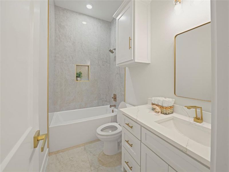 Bathroom featuring vanity,  shower combination, and light tile patterned flooring