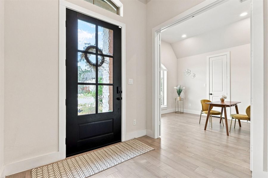 A welcoming entry, with durable wood-look flooring, leads into a bright, versatile space.