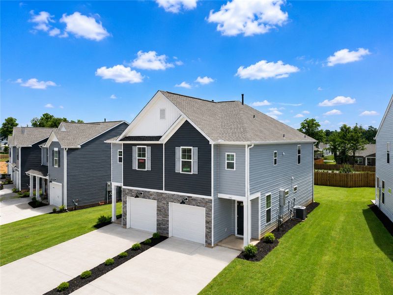 Front exterior of a new home in Champions Village at Cherry Hill, Pendleton, SC, highlighting curb appeal (Image 2). Front exterior of a new home in Champions Village at Cherry Hill, Pendleton, SC, highlighting curb appeal (Image 2).