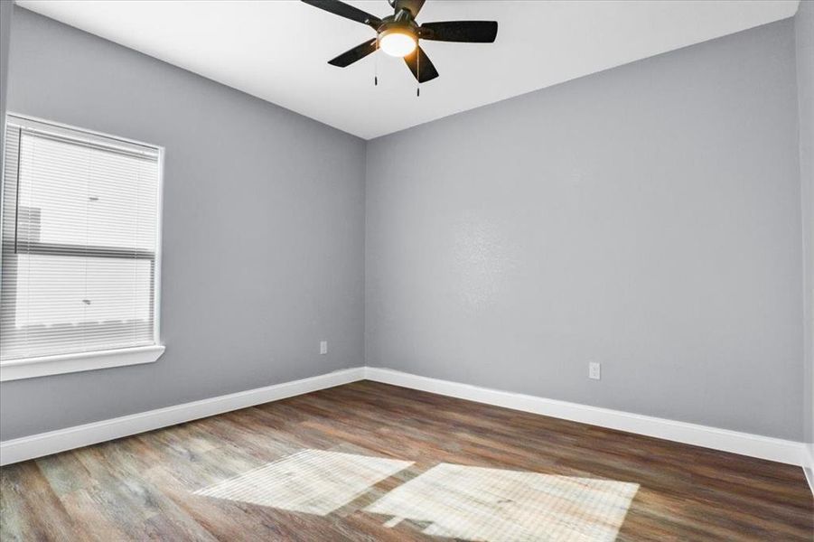 Spare room featuring hardwood / wood-style flooring and ceiling fan