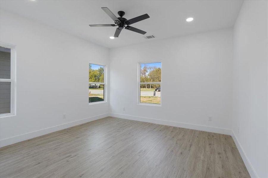 Unfurnished room featuring ceiling fan and light hardwood / wood-style flooring