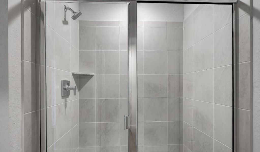 A shower with a glass door. A shower with a glass door.
