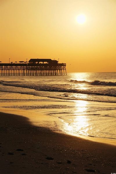 Water view with a pier and nearby beach