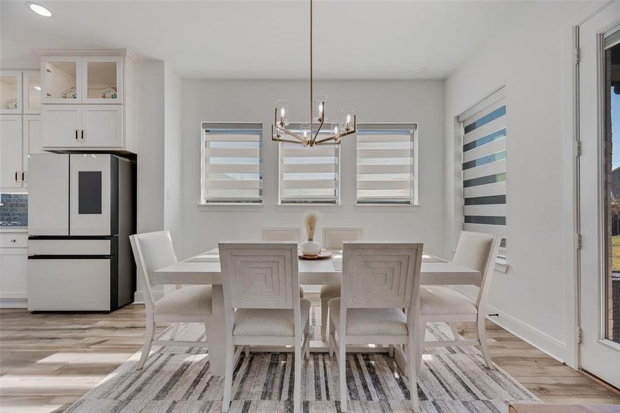 Dining area featuring a chandelier and light wood-style floors