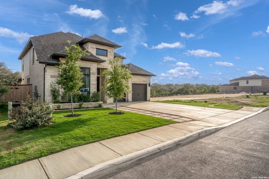 Front exterior of a new home in Ladera, San Antonio, TX, highlighting curb appeal (Image 26). Front exterior of a new home in Ladera, San Antonio, TX, highlighting curb appeal (Image 26).