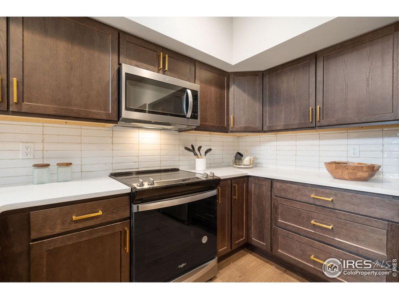 Stainless steel appliances and tile backsplash