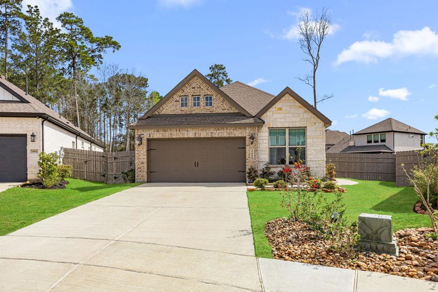 Front exterior of a new home in Artavia: Avante Collection, Conroe, TX, highlighting curb appeal (Image 25).