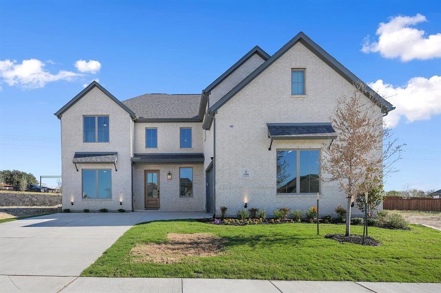 View of front of property featuring brick siding and roof with shingles View of front of property featuring brick siding and roof with shingles