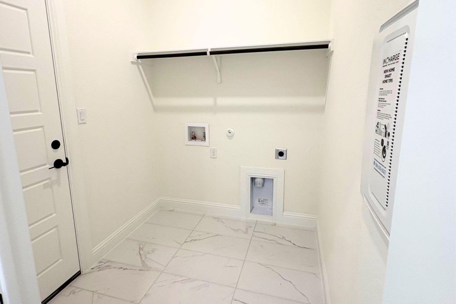 Polished tile flooring and integrated storage shelving define this utility area. Polished tile flooring and integrated storage shelving define this utility area.