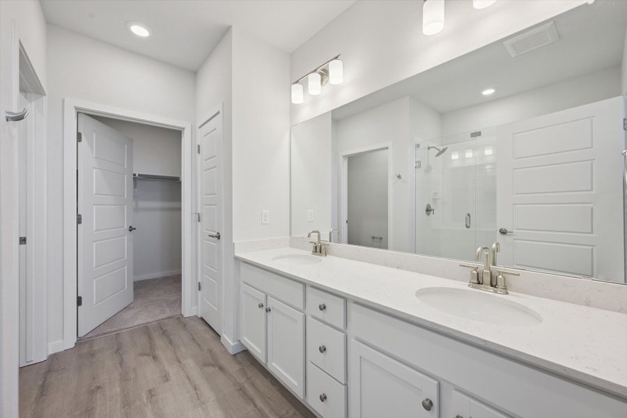 A bathroom with white cabinets. A bathroom with white cabinets.