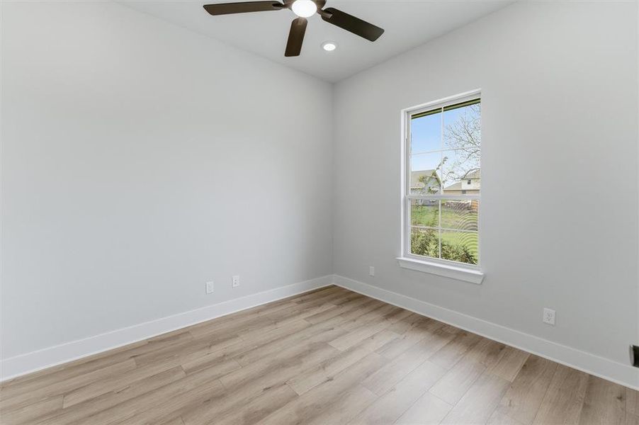 Unfurnished room featuring a ceiling fan, light wood-style floors, and recessed lighting
