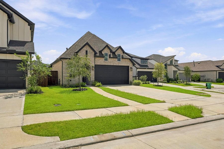 Front exterior of a new home in Meridiana, Iowa Colony, TX, highlighting curb appeal (Image 20).