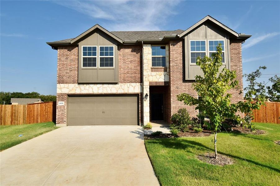 View of front facade featuring concrete driveway, brick siding, an attached garage, and a shingled roof