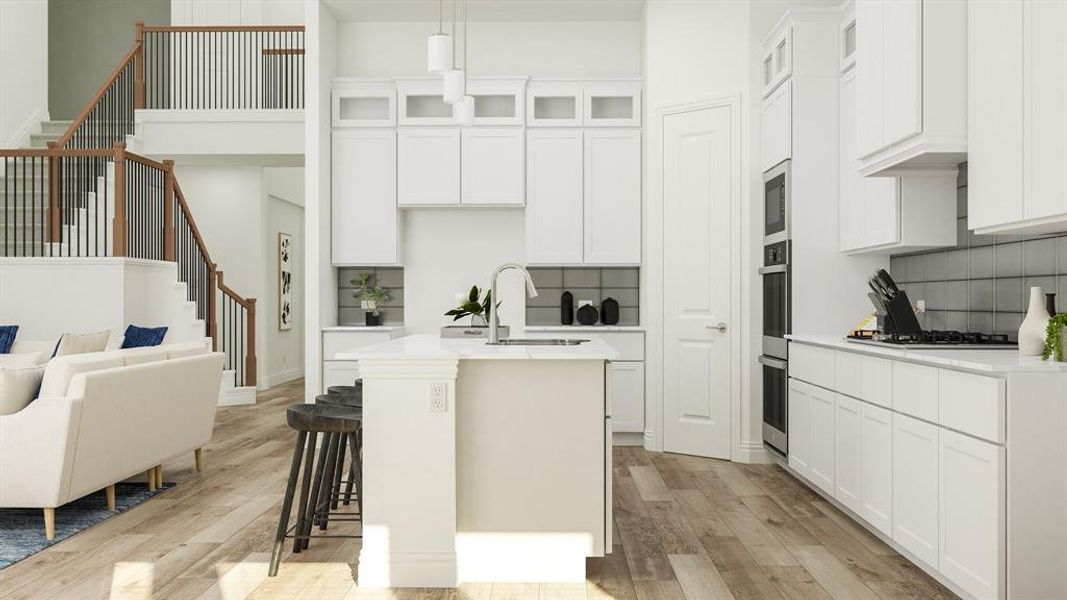 Kitchen with decorative backsplash, light hardwood / wood-style flooring, white cabinets, a center island with sink, and sink