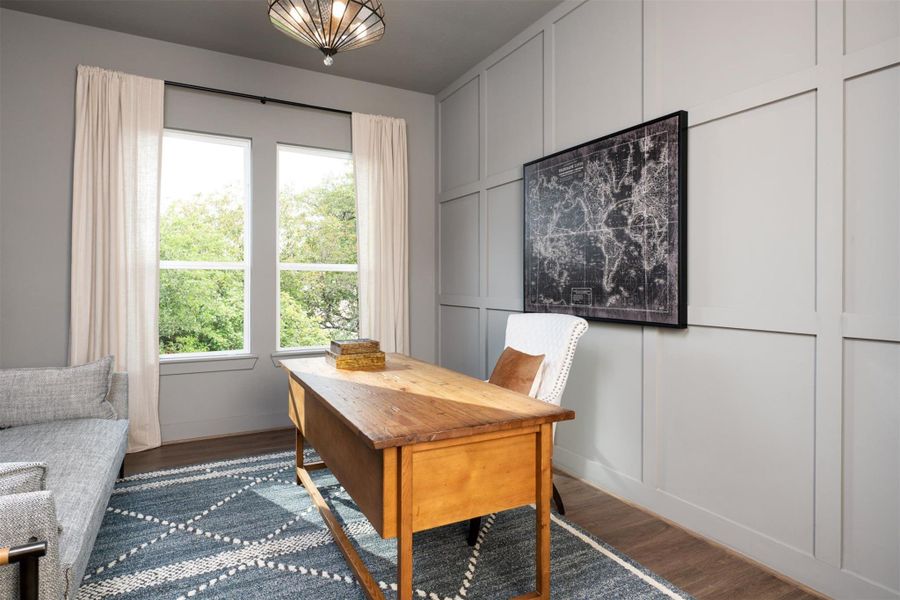 The home office features beautiful floors, large windows that give a fresh feel, this space promotes focus and creativity.