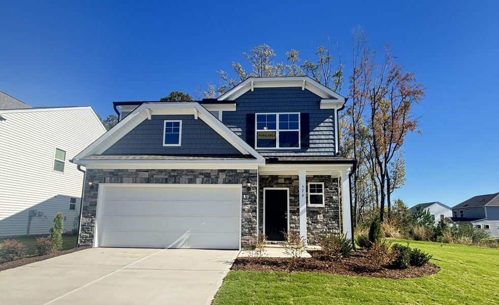 Front exterior of a new home in Daniel Farms, Benson, NC, highlighting curb appeal (Image 1).