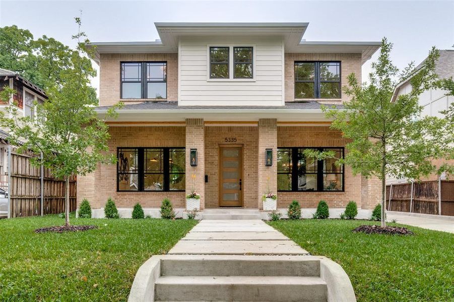 View of front of property featuring a porch, brick siding, and a front yard View of front of property featuring a porch, brick siding, and a front yard