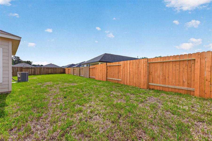 Exterior details and patio area of a home in Woodland Lakes, Huffman (Image 3).