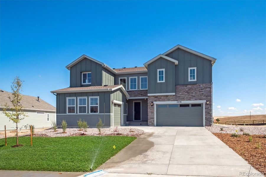 Front exterior of a new home in Trails at Smoky Hill, Parker, CO, highlighting curb appeal (Image 13).
