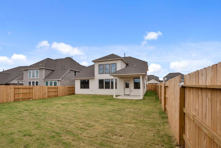 Exterior details and patio area of a home in Spring Creek Trails, Magnolia (Image 3).