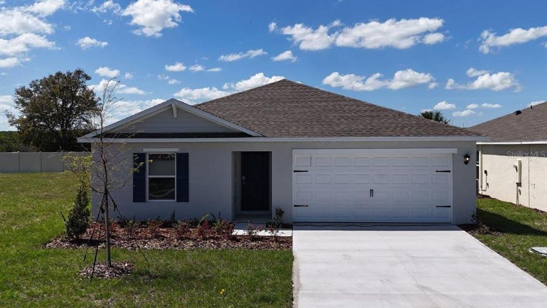 Front exterior of a new home in Magnolia Pointe, Umatilla, FL, highlighting curb appeal (Image 1). Front exterior of a new home in Magnolia Pointe, Umatilla, FL, highlighting curb appeal (Image 1).