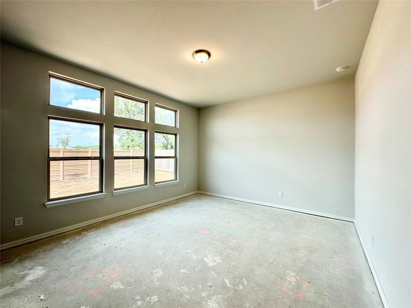 Empty room with baseboards and unfinished concrete floors Empty room with baseboards and unfinished concrete floors