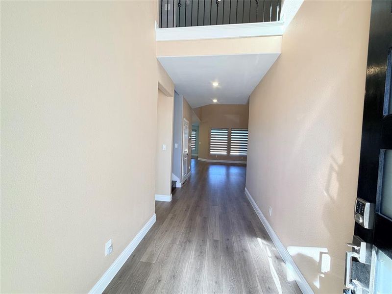 Corridor with baseboards and wood finished floors Corridor with baseboards and wood finished floors