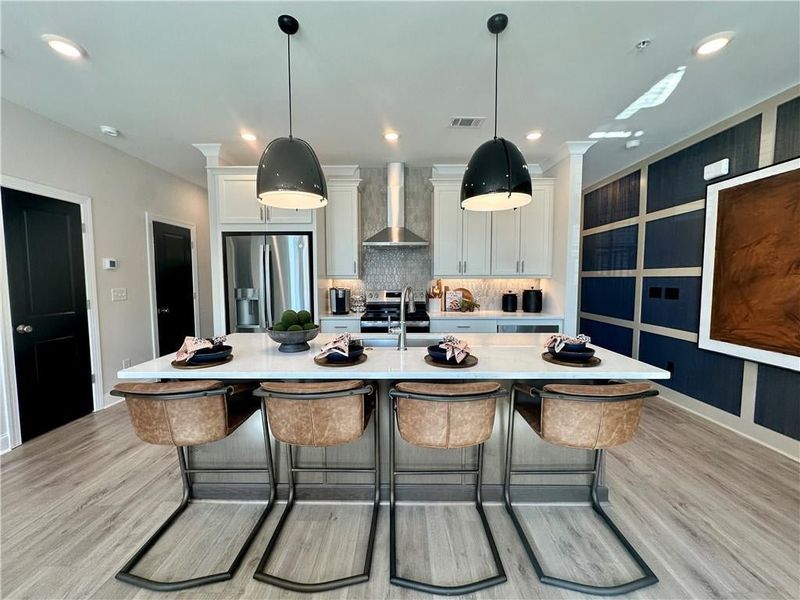 8ft quartz island paired with soft close cabinets & under cabinet lighting *Images shown are from a decorated model of the same floor plan. Design selections and color packages will vary by home.*