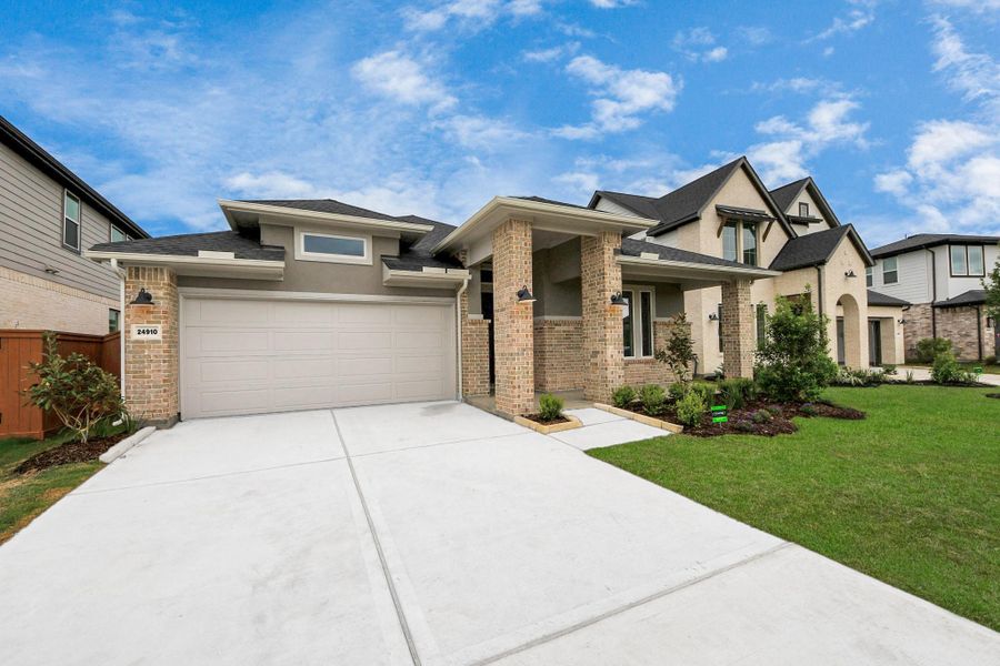 Front exterior of a new home in 50' Traditional Homes at Elyson, Katy, TX, highlighting curb appeal (Image 17). Front exterior of a new home in 50' Traditional Homes at Elyson, Katy, TX, highlighting curb appeal (Image 17).