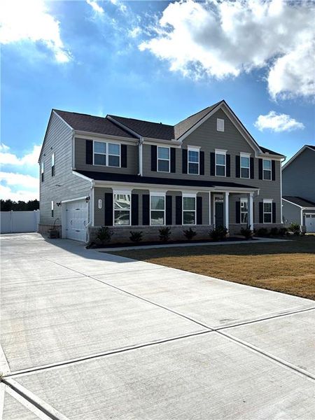 Front exterior of a new home in , Locust Grove, GA, highlighting curb appeal (Image 1). Front exterior of a new home in , Locust Grove, GA, highlighting curb appeal (Image 1).